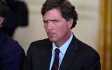 Tucker Carlson attends a meeting with US President Donald Trump and oil executives in the East Room of the White House, January 9, 2026, in Washington. (AP Photo/Alex Brandon)