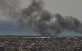 A Middle East Airlines plane takes off from Rafik Hariri International Airport as smoke rises from the site of an Israeli airstrike in Dahiyeh, Beirut's southern suburbs, Lebanon, March 17, 2026. (Hassan Ammar/AP)