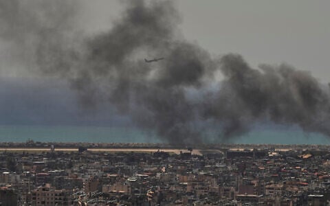 A Middle East Airlines plane takes off from Rafik Hariri International Airport as smoke rises from the site of an Israeli airstrike in Dahiyeh, Beirut's southern suburbs, Lebanon, March 17, 2026. (Hassan Ammar/AP)