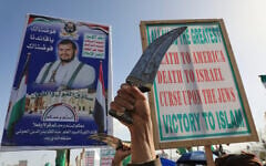 Houthi supporters raise a banner showing their leader Abdul Malik al-Houthi, during a rally against Israel and the United States' war with Iran, in Sanaa, Yemen, April 3, 2026. (AP/Osamah Abdulrahman)