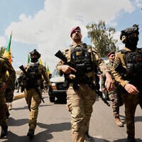 Members of an Iraqi Shiite group attend a funeral of a fighter with the Kataeb Hezbollah, who was killed in a US airstrike in Basra province south of Baghdad, Iraq, on April 8, 2026. (AP Photo/Hadi Mizban)