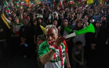 A man wearing a shirt bearing Iran's national soccer team logo blows a plastic trumpet during a pro-government gathering in support of Iran's World Cup team at Islamic Revolution Square in Tehran, Iran, Wednesday, May 13, 2026. (AP Photo/Vahid Salemi)