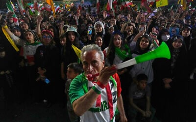 A man wearing a shirt bearing Iran's national soccer team logo blows a plastic trumpet during a pro-government gathering in support of Iran's World Cup team at Islamic Revolution Square in Tehran, Iran, Wednesday, May 13, 2026. (AP Photo/Vahid Salemi) A man wearing a shirt bearing Iran's national soccer team logo blows a plastic trumpet during a pro-government gathering in support of Iran's World Cup team at Islamic Revolution Square in Tehran, Iran, Wednesday, May 13, 2026. (AP Photo/Vahid Salemi)