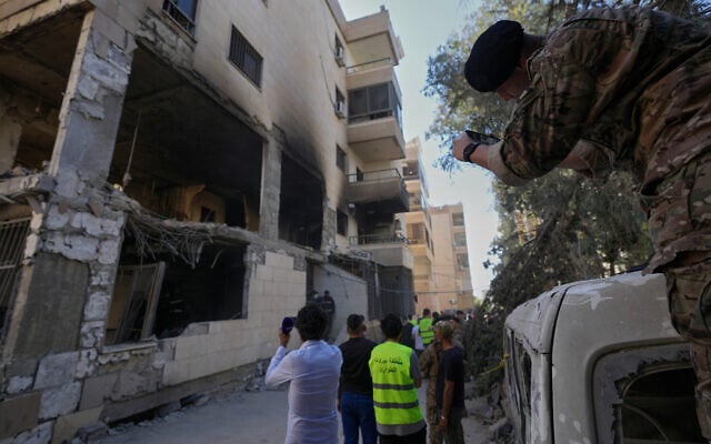 A Lebanese soldier takes pictures by his phone for a destroyed apartment that was hit in an Israeli airstrike in Choueifat town, southern Beirut, Lebanon, May 28, 2026. (AP Photo/Hussein Malla)