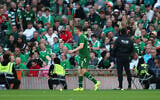 Ireland's Seamus Coleman walks as tennis balls are thrown on to the pitch during the international friendly soccer match between Ireland and Qatar in Dublin, Ireland, May 28, 2026. (AP Photo/ Peter Morrison)