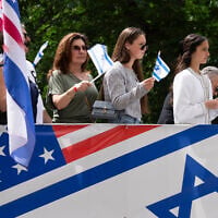 Parade participants wave flags at spectators during the Israel Day Parade, May 31, 2026, in New York. (AP/Emil T. Lippe)