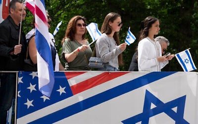 Parade participants wave flags at spectators during the Israel Day Parade, May 31, 2026, in New York. (AP/Emil T. Lippe)