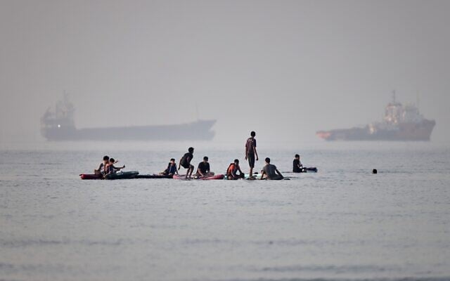 People gather on paddleboards in shallow water as cargo and service vessels are anchored in the Strait of Hormuz off Bandar Abbas, Iran, June 1, 2026. (Amirhosein Khorgooi/ISNA via AP) People gather on paddleboards in shallow water as cargo and service vessels are anchored in the Strait of Hormuz off Bandar Abbas, Iran, June 1, 2026. (Amirhosein Khorgooi/ISNA via AP)