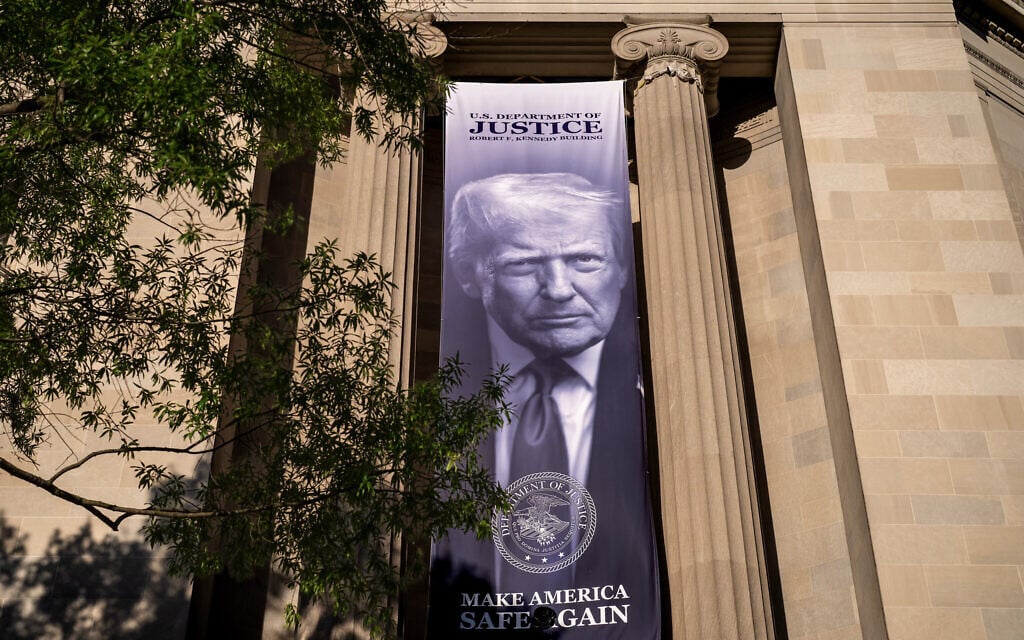 A giant portrait of President Donald Trump looks down from the Justice Department in Washington, Tuesday, June 2, 2026. (AP Photo/J. Scott Applewhite)