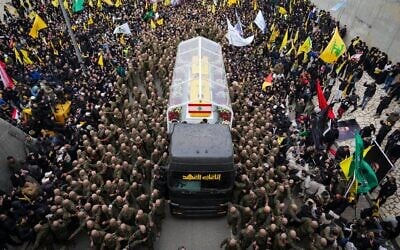 A trailer carrying the coffins containing the bodies of Hezbollah's former leader Hassan Nasrallah and his cousin and successor Hashem Safieddine drives through the crowd as it enters the Sports City Stadium during a funeral procession in Beirut, February 23, 2025. (Hassan Ammar/AP)