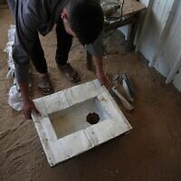 Akram Awwad works on a locally manufactured toilet, in Khan Younis, southern Gaza Strip, Wednesday, June 3, 2026. (AP Photo/Abdel Kareem Hana)