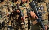 Members of the Saraya al-Salam Shiite militia attend a ceremony marking the start of the process of handing over their weapons to Iraqi state forces in Samarra, north of Baghdad, Iraq, June 4, 2026. (AP Photo/Anmar Khalil)