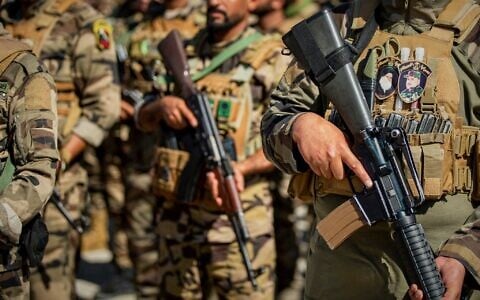 Members of the Saraya al-Salam Shiite militia attend a ceremony marking the start of the process of handing over their weapons to Iraqi state forces in Samarra, north of Baghdad, Iraq, June 4, 2026. (AP Photo/Anmar Khalil)