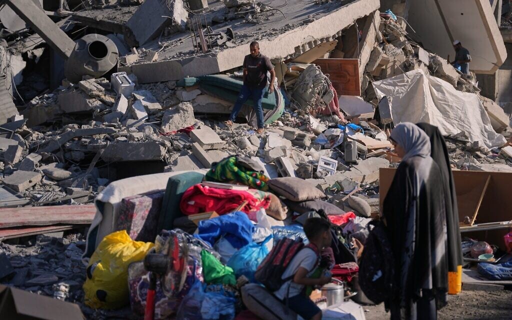 Palestinians inspect the rubble of a building destroyed in an Israeli strike in Zawaida, in the central Gaza Strip, June 5, 2026. (AP Photo/Abdel Kareem Hana)