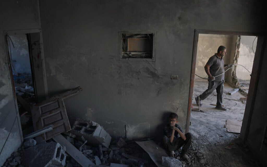 Mohammed Saidam, 14, sits in a room of a heavily damaged apartment following an Israeli strike in Zawaida, in the central Gaza Strip, June 5, 2026. (AP Photo/Abdel Kareem Hana)