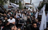 FILE - Sunni Muslims hold a portrait of imprisoned Sunni cleric Ahmad al-Assir, center right, during a protest against the clause in a proposed amnesty law that would exclude some prisoners, including the cleric, from being eligible for amnesty, after Friday prayers in Beirut, Lebanon, May 22, 2026. (AP Photo/Bilal Hussein, File)