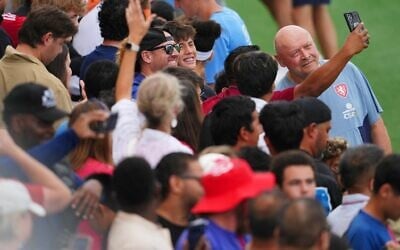 Miroslav Koubek, right, head coach of the Czechia men's national soccer team, poses for a selfie with a supporter during a public training session, Saturday, June 6, 2026, in Mansfield, Texas, ahead of the World Cup soccer tournament. (AP Photo/Julio Cortez)