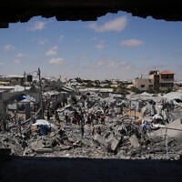 Palestinians inspect the rubble of a building destroyed in an Israeli airstrike in Khan Younis, in the southern Gaza Strip, June 7, 2026. (AP Photo/Abdel Kareem Hana)