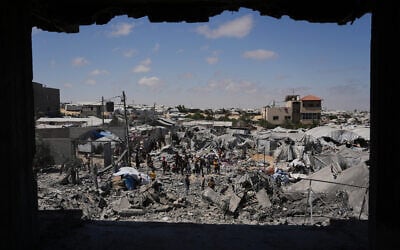 Palestinians inspect the rubble of a building destroyed in an Israeli airstrike in Khan Younis, in the southern Gaza Strip, June 7, 2026. (AP Photo/Abdel Kareem Hana)