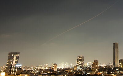 A projectile streaks through the sky over central Israel during an Iranian missile attack, June 7, 2026. (AP Photo/Ohad Zwigenberg)