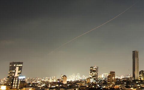 A projectile streaks through the sky over central Israel during an Iranian missile attack, June 7, 2026. (AP Photo/Ohad Zwigenberg)