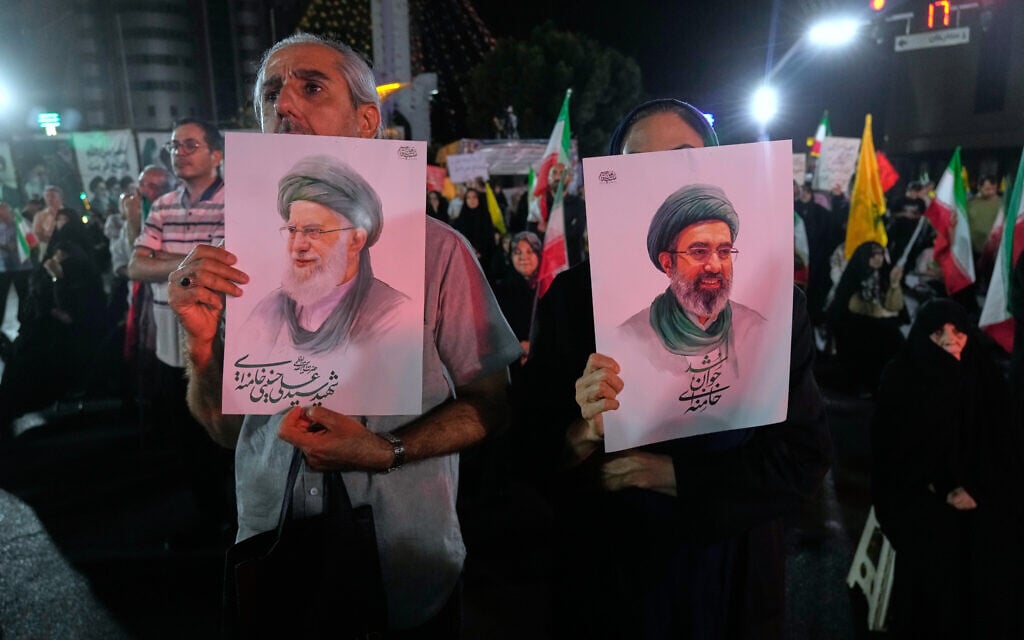 Pro-government Iranian demonstrators hold posters of the Supreme Leader Ayatollah Mojtaba Khamenei, right, and his father Ali Khamenei, who was killed in US and Israeli strikes on February 28, at a celebratory gathering in Tehran, Iran following fresh missile strikes on Israel, on June 7, 2026. (AP/Vahid Salemi)