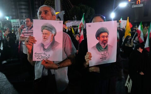Pro-government Iranian demonstrators hold posters of the Supreme Leader Ayatollah Mojtaba Khamenei, right, and his father Ali Khamenei, who was killed in US and Israeli strikes on February 28, at a celebratory gathering in Tehran, Iran following fresh missile strikes on Israel, on June 7, 2026. (AP/Vahid Salemi)
