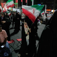A girl waves an Iranian flag in a pro-government gathering in Tehran, Iran, June 7, 2026. (AP Photo/Vahid Salemi)
