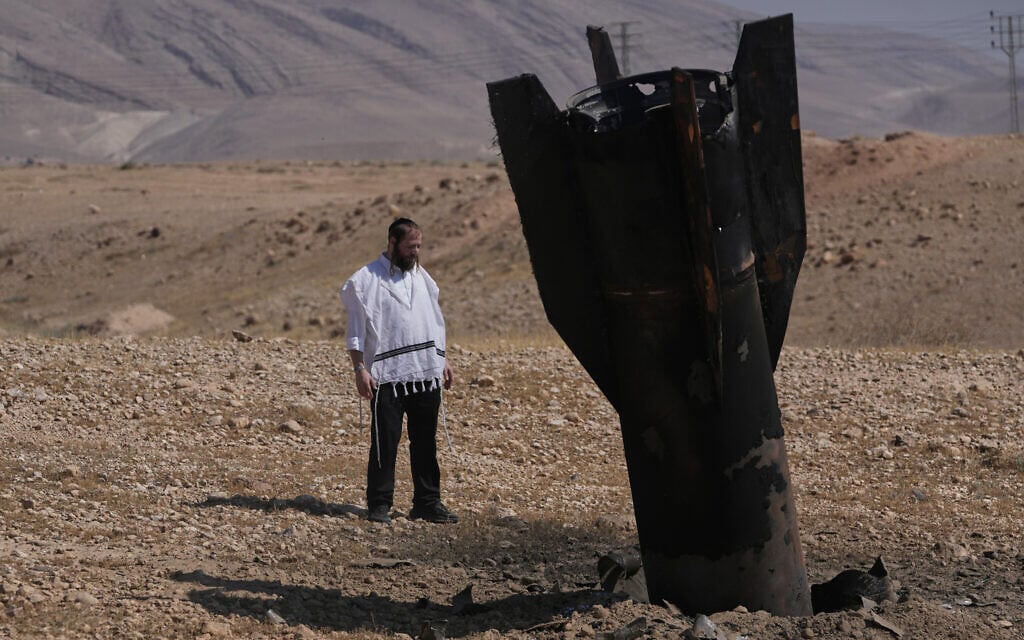 A man looks at the wreckage of an Iranian missile that landed near the West Bank city of Jericho, June 8, 2026. (AP Photo/Mahmoud Illean)