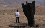 A man looks at the wreckage of an Iranian missile that landed near the West Bank city of Jericho, June 8, 2026. (AP Photo/Mahmoud Illean)