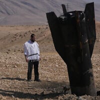 A man looks at the wreckage of an Iranian missile that landed near the West Bank city of Jericho, June 8, 2026. (AP Photo/Mahmoud Illean)