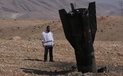 A man looks at the wreckage of an Iranian missile that landed near the West Bank city of Jericho, June 8, 2026. (AP Photo/Mahmoud Illean)