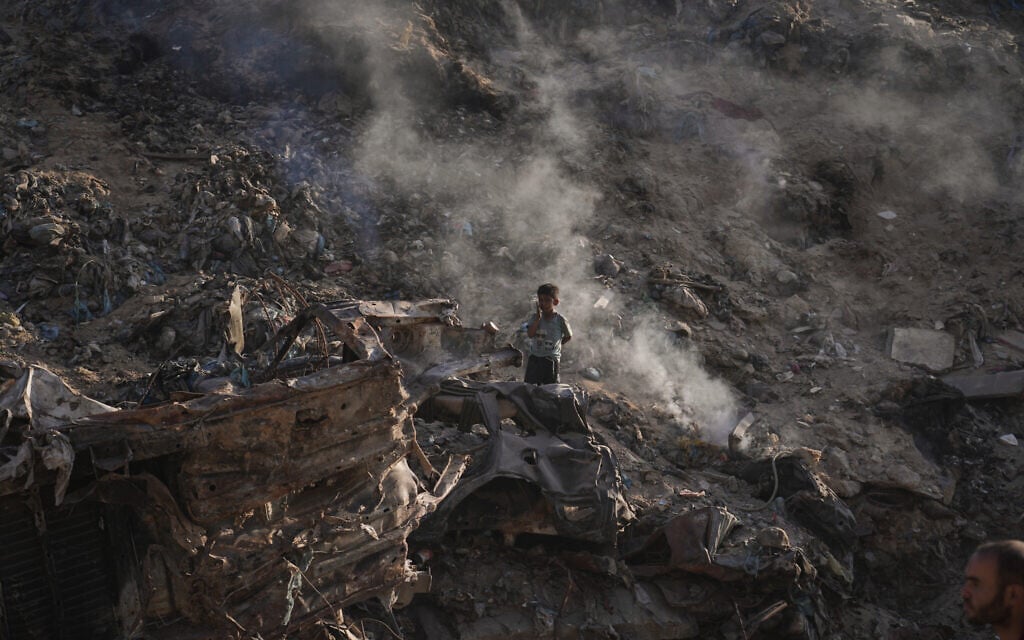 A child walks amid rubble and landfill in Gaza City, June 8, 2026. (AP Photo/Jehad Alshrafi)