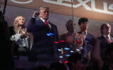 US President Donald Trump gestures during the National Anthem as he attends an NBA Finals playoff basketball game between the New York Knicks and the San Antonio Spurs at Madison Square Garden in New York, June 8, 2026, with Kai Trump, left, Knicks owner James Dolan and Interior Secretary Doug Burgum, right. (Mark Schiefelbein/AP)