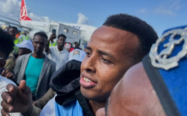 Referee Omar Artan, who was denied entry to the United States, is welcomed by supporters upon his arrival in Mogadishu, Somalia, June 10, 2026. (AP Photo/Farah Abdi Warsameh)