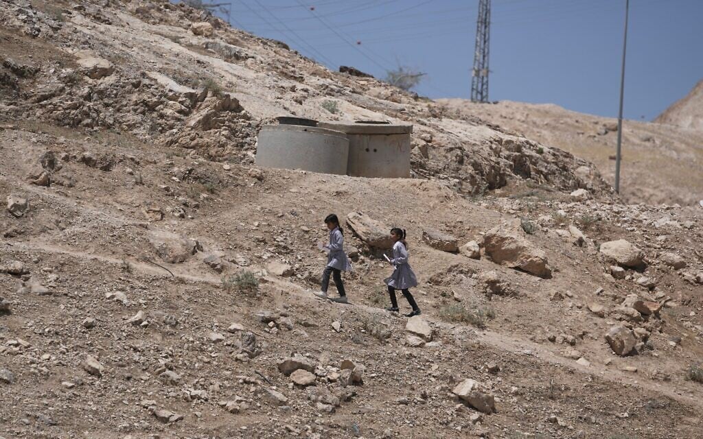 Palestinian students walk on their way home after receiving their year end reports from school, in the West Bank Bedouin hamlets of Khan al-Ahmar, June 10, 2026. (AP Photo/Mahmoud Illean)