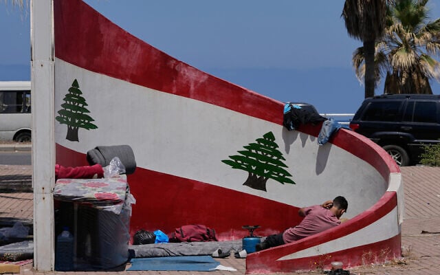 A displaced man who fled his village in south Lebanon lies next to his belongings on a sidewalk in the southern port city of Sidon, Lebanon, June 10, 2026. (AP Photo/Mohammed Zaatari) A displaced man who fled his village in south Lebanon lies next to his belongings on a sidewalk in the southern port city of Sidon, Lebanon, June 10, 2026. (AP Photo/Mohammed Zaatari)