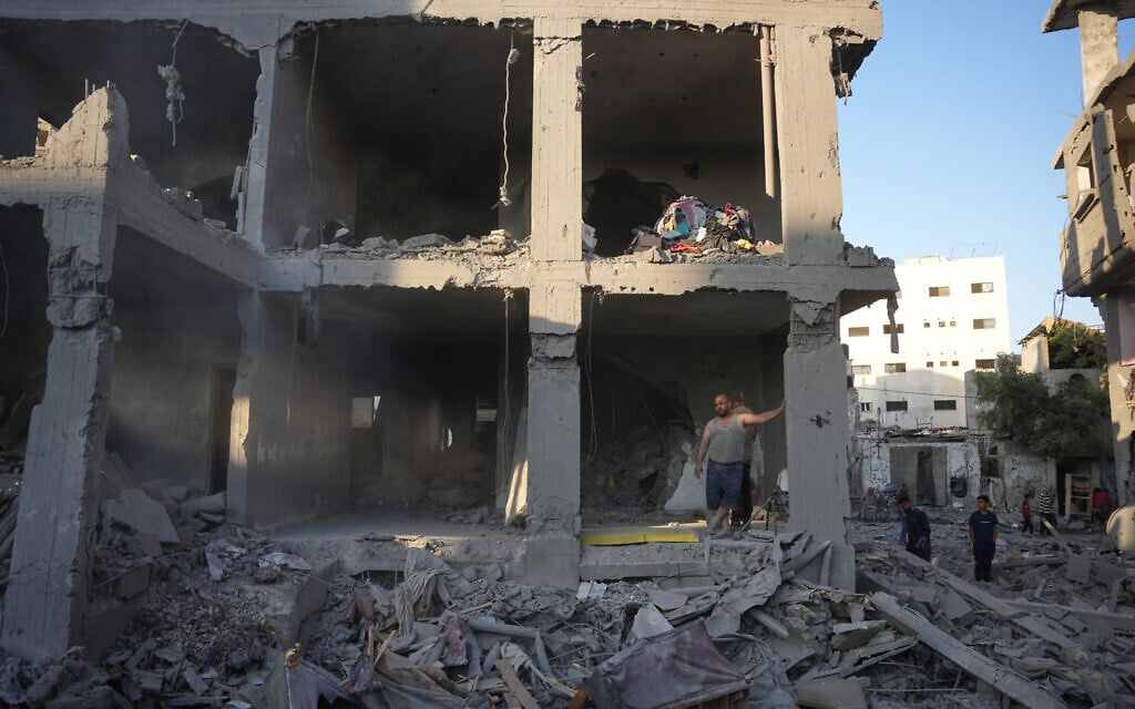 Palestinians clear the rubble of a building that was destroyed in an Israeli airstrike, at al-Maghazi refugee camp, central Gaza Strip, June 12, 2026. (AP Photo/Abdel Kareem Hana)