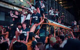 New York Knicks fans celebrate in the streets after the Knicks defeated the San Antonio Spurs to win the NBA Finals, on June 13, 2026, in New York. (AP Photo/Andres Kudacki)