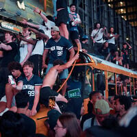 New York Knicks fans celebrate in the streets after the Knicks defeated the San Antonio Spurs to win the NBA Finals, on June 13, 2026, in New York. (AP Photo/Andres Kudacki)