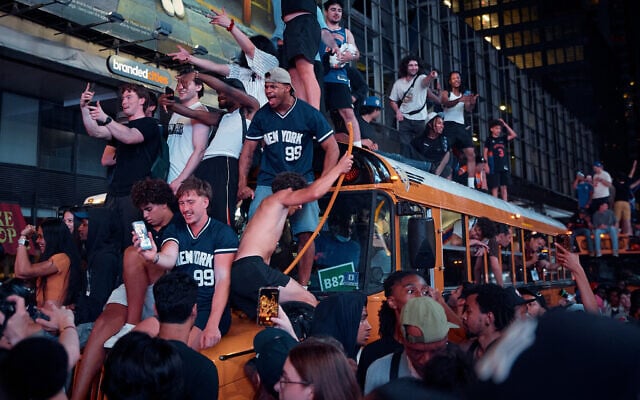 New York Knicks fans celebrate in the streets after the Knicks defeated the San Antonio Spurs to win the NBA Finals, on June 13, 2026, in New York. (AP Photo/Andres Kudacki)