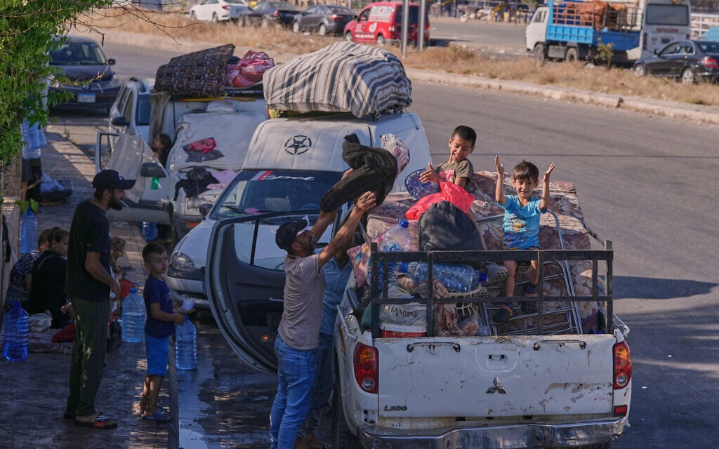 Displaced people pack their belongings as they prepare to return to their village following the announcement of an initial ceasefire agreement between the United States and Iran, in the southern port city of Sidon, Lebanon, Monday, June 15, 2026. (AP Photo/Mohammed Zaatari)
