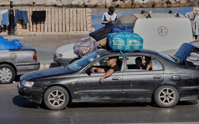 A displaced family with their belongings, return to their village following the announcement of an initial ceasefire agreement between the United States and Iran, in the southern port city of Sidon, Lebanon, Monday, June 15, 2026.(AP Photo/Mohammed Zaatari)