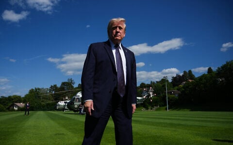 US President Donald Trump walks towards reporters as he arrives for the G7 summit, June 15, 2026, in Evian-les-Bains, France. (AP/Julia Demaree Nikhinson)