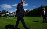 President Donald Trump waves to reporters as he arrives for the G7 summit, June 15, 2026, in Evian-les-Bains, France. (AP Photo/Julia Demaree Nikhinson)