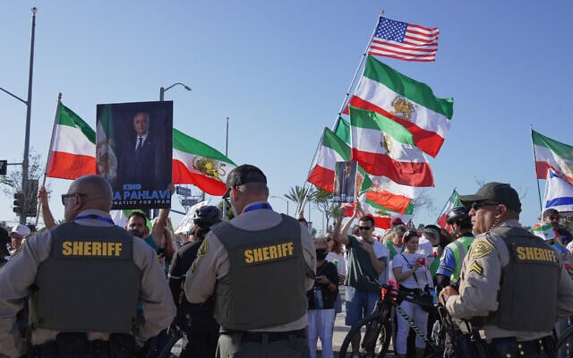 Law enforcement personnel keep a watch on a protest outside Los Angeles Stadium before the World Cup Group G soccer match between Iran and New Zealand in Inglewood, California, near Los Angeles, June 15, 2026. (AP/Ty ONeil)
