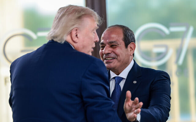 US President Donald Trump (L) greets Egyptian President Abdel-Fattah el-Sissi (R) at a working lunch with leaders of G7 and the Middle East, in Evian-les-Bains, France, June 16, 2026. (Evelyn Hockstein/ Pool Photo via AP)