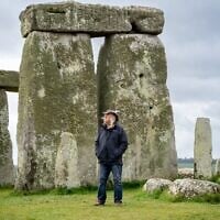 This photo provided by Wessex Archaeology shows archaeologist Phil Harding standing at Stonehenge in May 2026, near Salisbury, England. (Wessex Archaeology via AP)