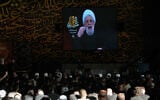 Hezbollah leader Sheikh Naim Qassem, is seen on a screen during a sermon marking the first day of Ashoura, at the grave of late Hezbollah leader Sayyed Hassan Nasrallah, left, in Beirut, Lebanon, June 17, 2026. (AP Photo/ Hussein Malla)