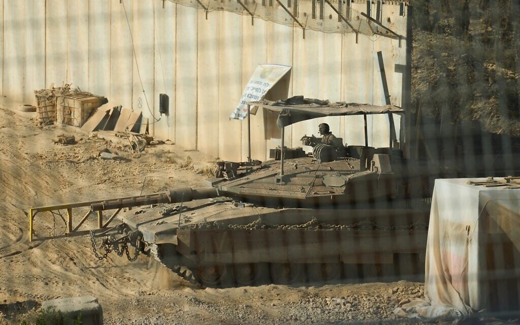 Israeli soldiers cross with a tank from southern Lebanon into northern Israel, June 18, 2026. (AP Photo/Ariel Schalit)